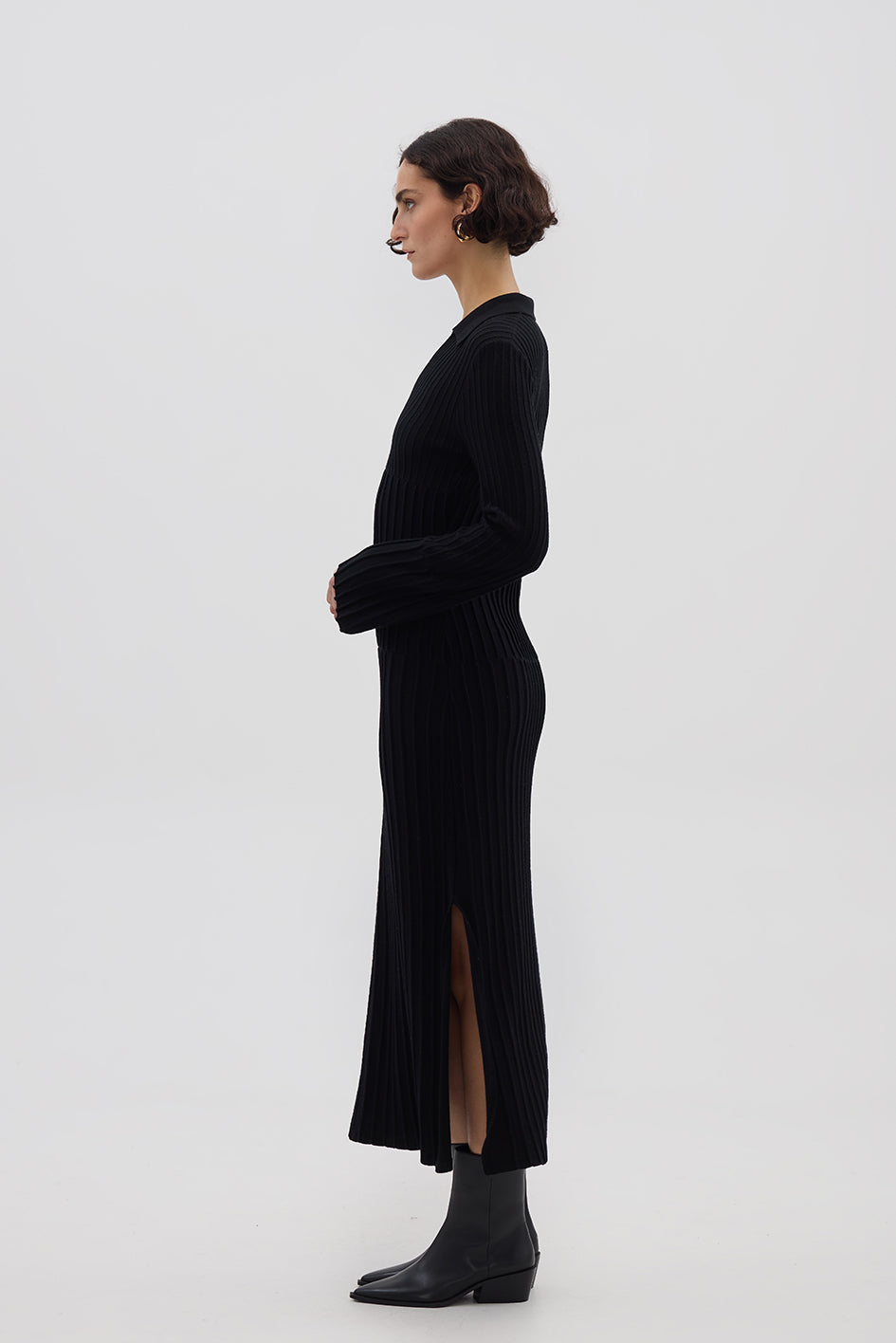 Side profile of model in Black Merino Dress – sleek, structured, and timeless knitwear