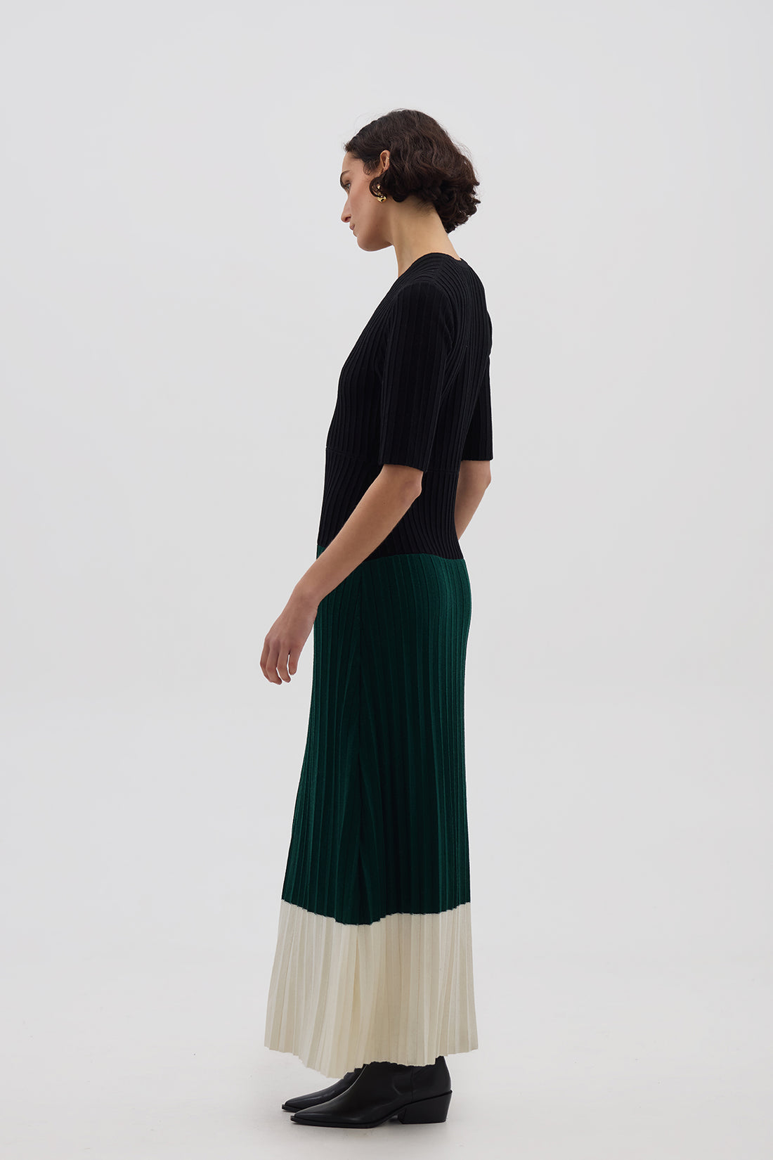 Side profile of model in Black & Emerald Merino Dress – structured, soft, and effortlessly stylish