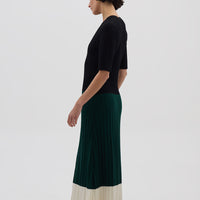Side profile of model in Black & Emerald Merino Dress – structured, soft, and effortlessly stylish