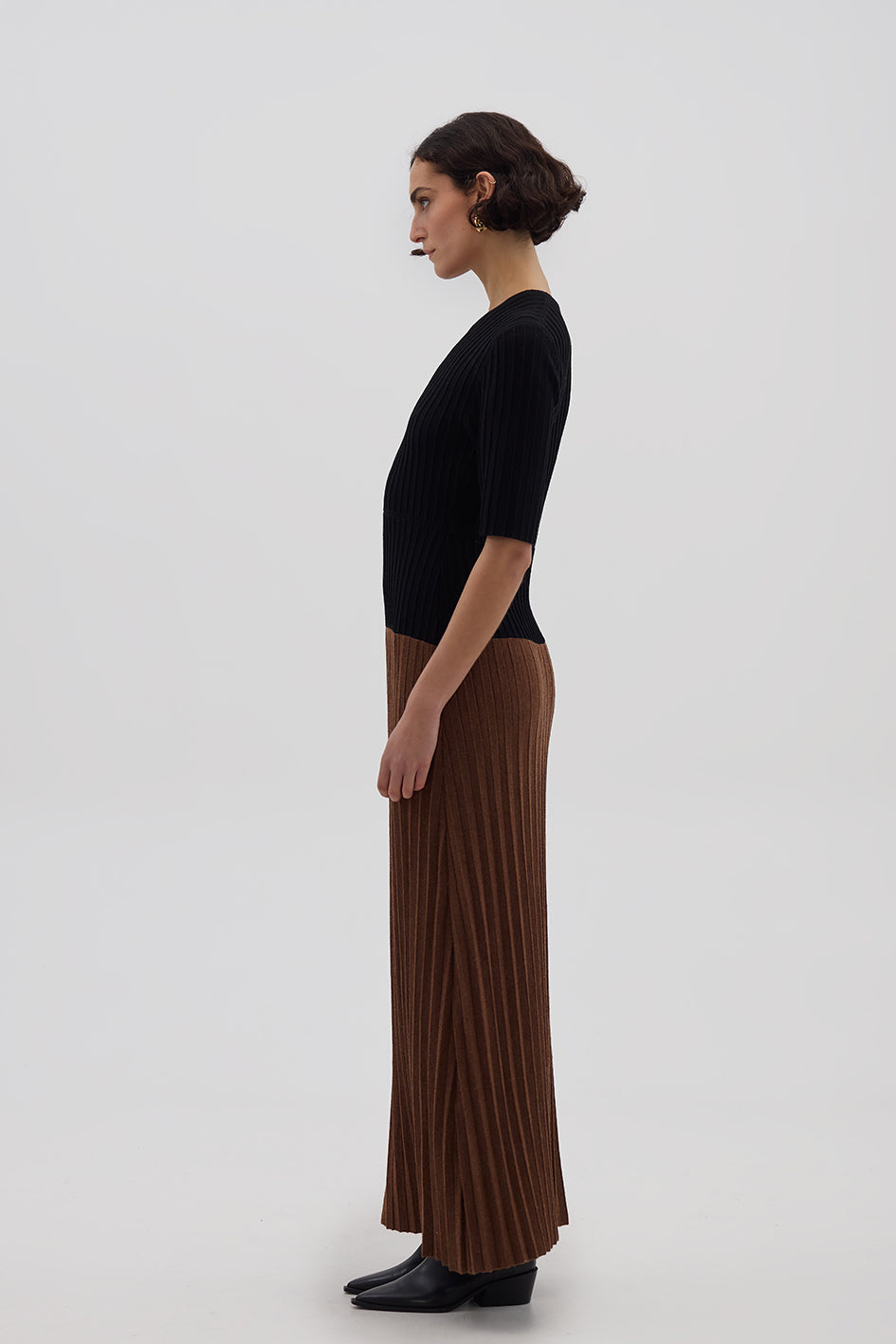 Side profile of model in Black & Walnut Merino Dress – soft, structured, and effortlessly chic