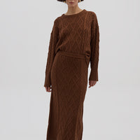 Model wearing the Brown Heart Cable Maxi Wool Skirt – soft and structured knit skirt