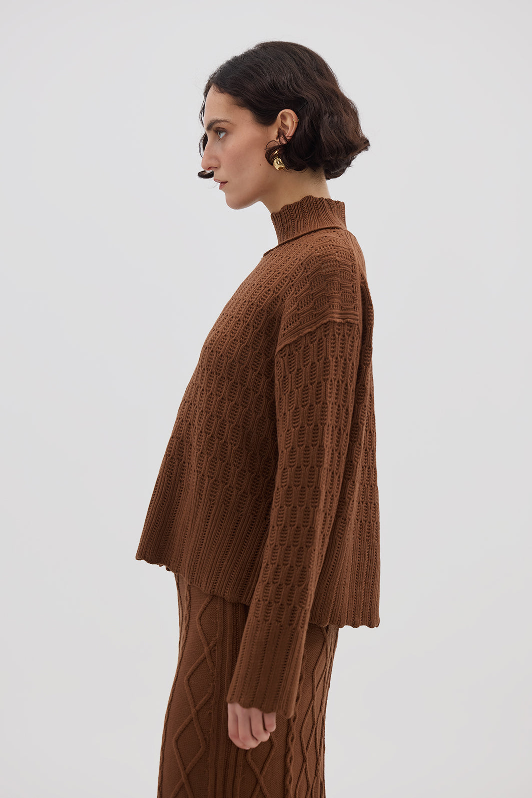 Side profile of model in Brown High Neck Wool Sweater – effortlessly elegant and warm