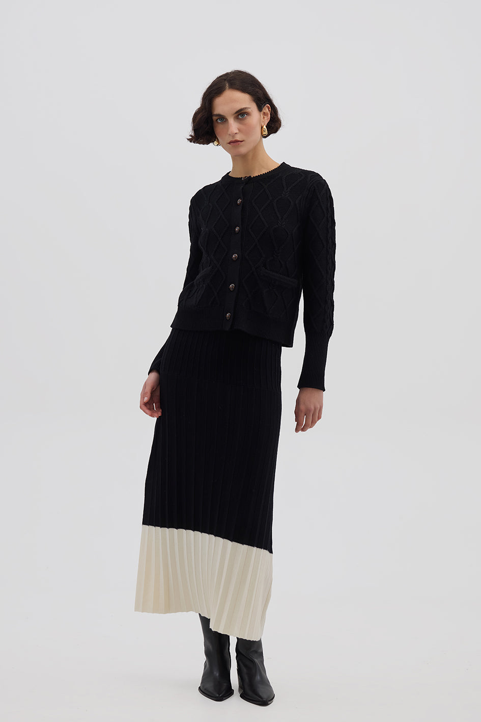 Model wearing the Black Colour Block Pleat Wool Skirt – elegant and breathable midi wool skirt