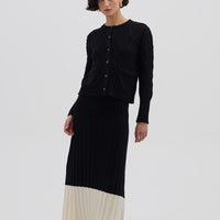 Model wearing the Black Colour Block Pleat Wool Skirt – elegant and breathable midi wool skirt