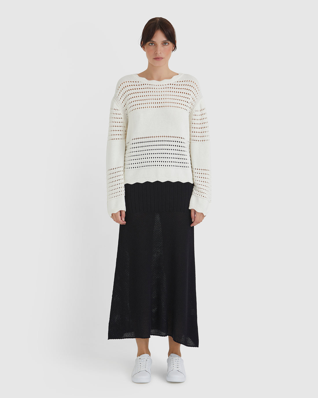 Lightweight wool sweater in cream with crochet detailing, perfect for layering.