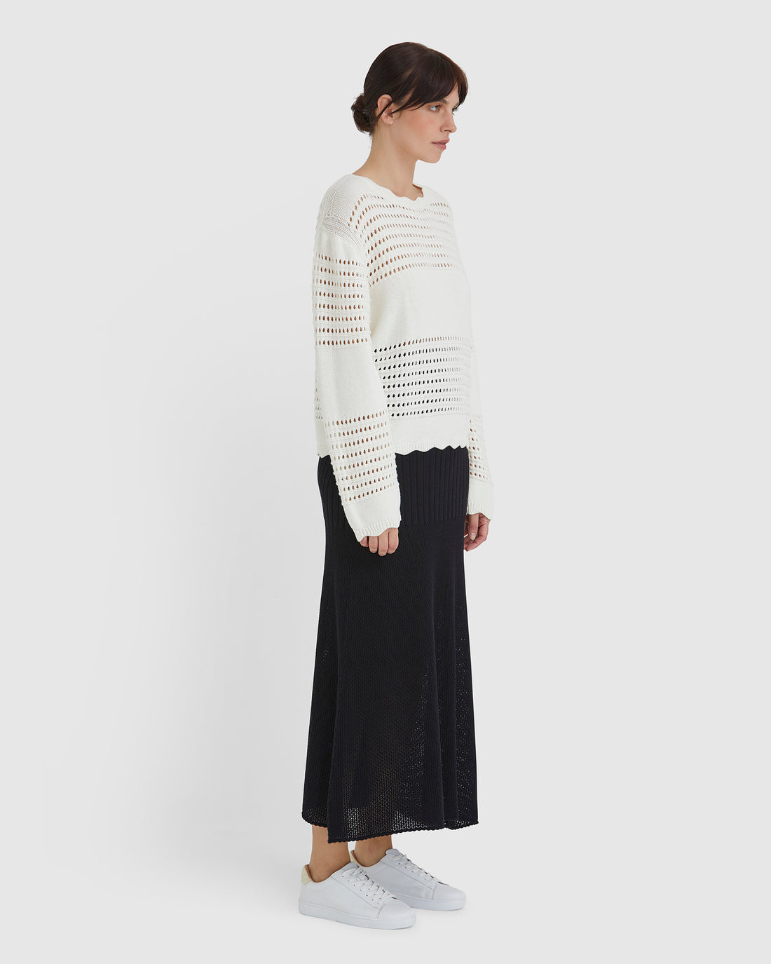Elegant crochet top styled with ribbed panels, ideal for summer and transitional wear.