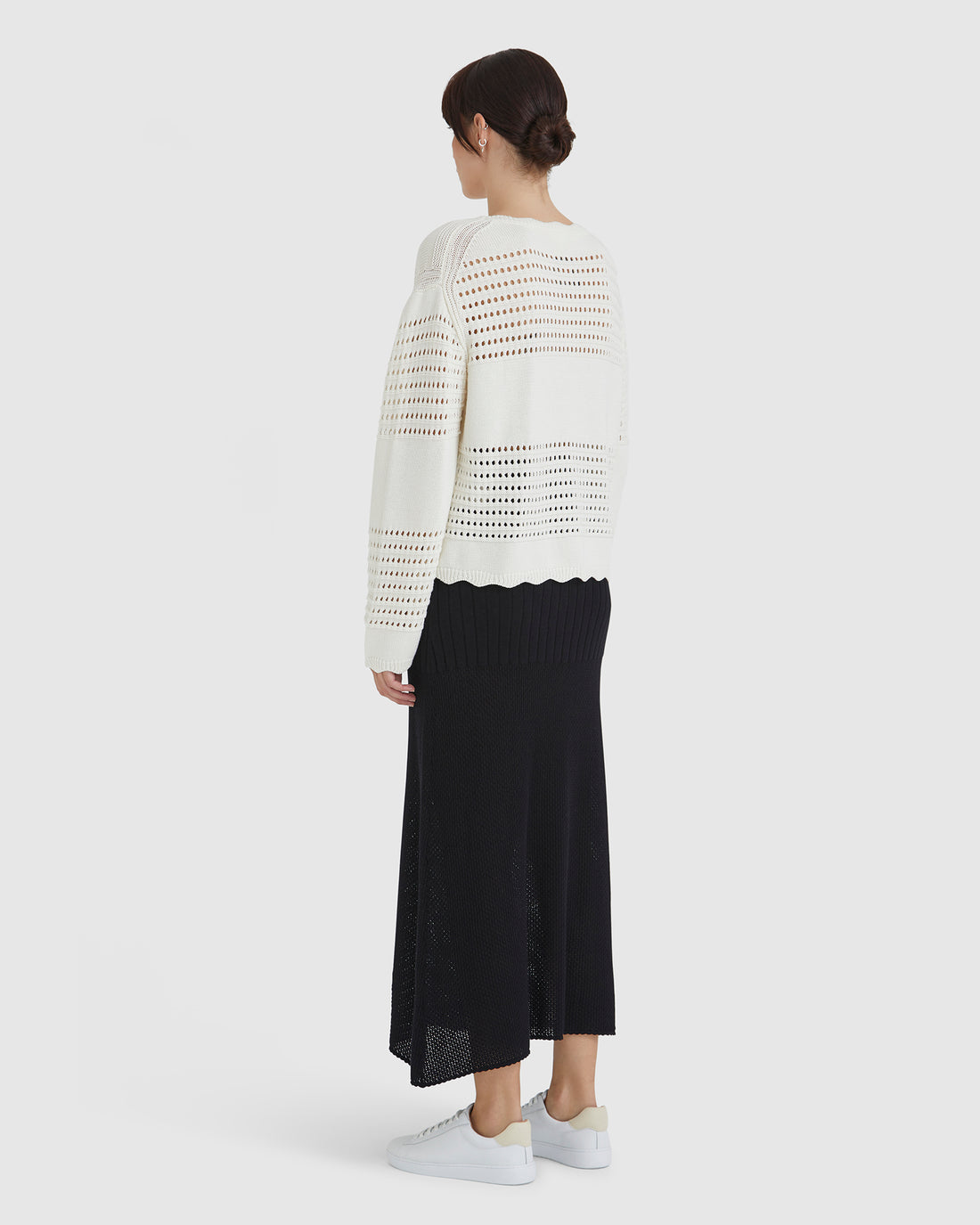 delicately crocheted sweater with intricate cut-out detailing.