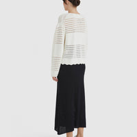 delicately crocheted sweater with intricate cut-out detailing.