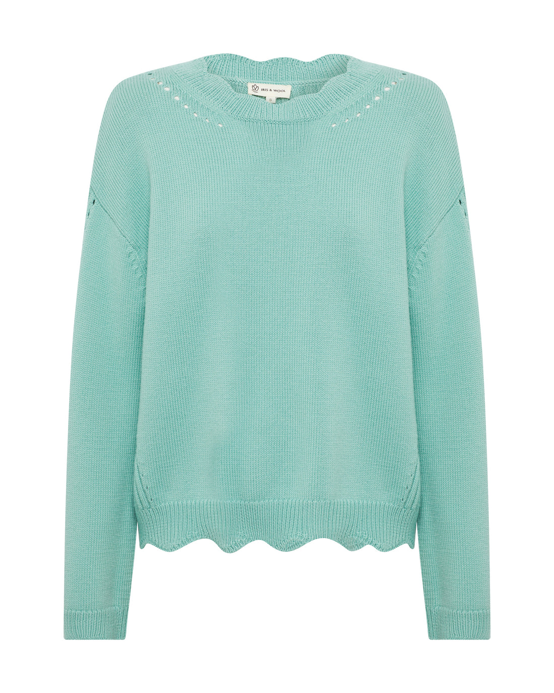 The image shows a sage wool sweater featuring a soft, smooth knit texture.