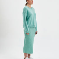 Elegant sage womens knit sweater with scalloped edges and cozy wool texture.