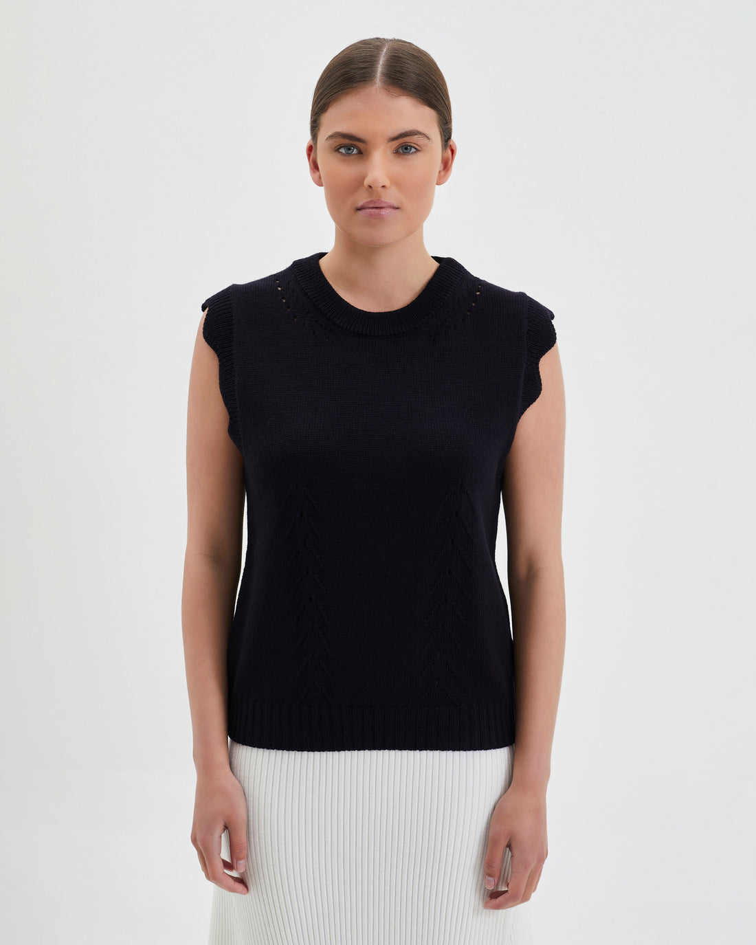 Black Scallop Vest with scalloped sleeves and crew neckline in merino wool.