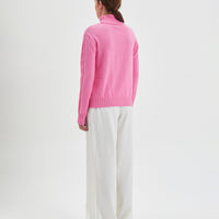 Merino wool cable knit sweater in candy for winter warmth