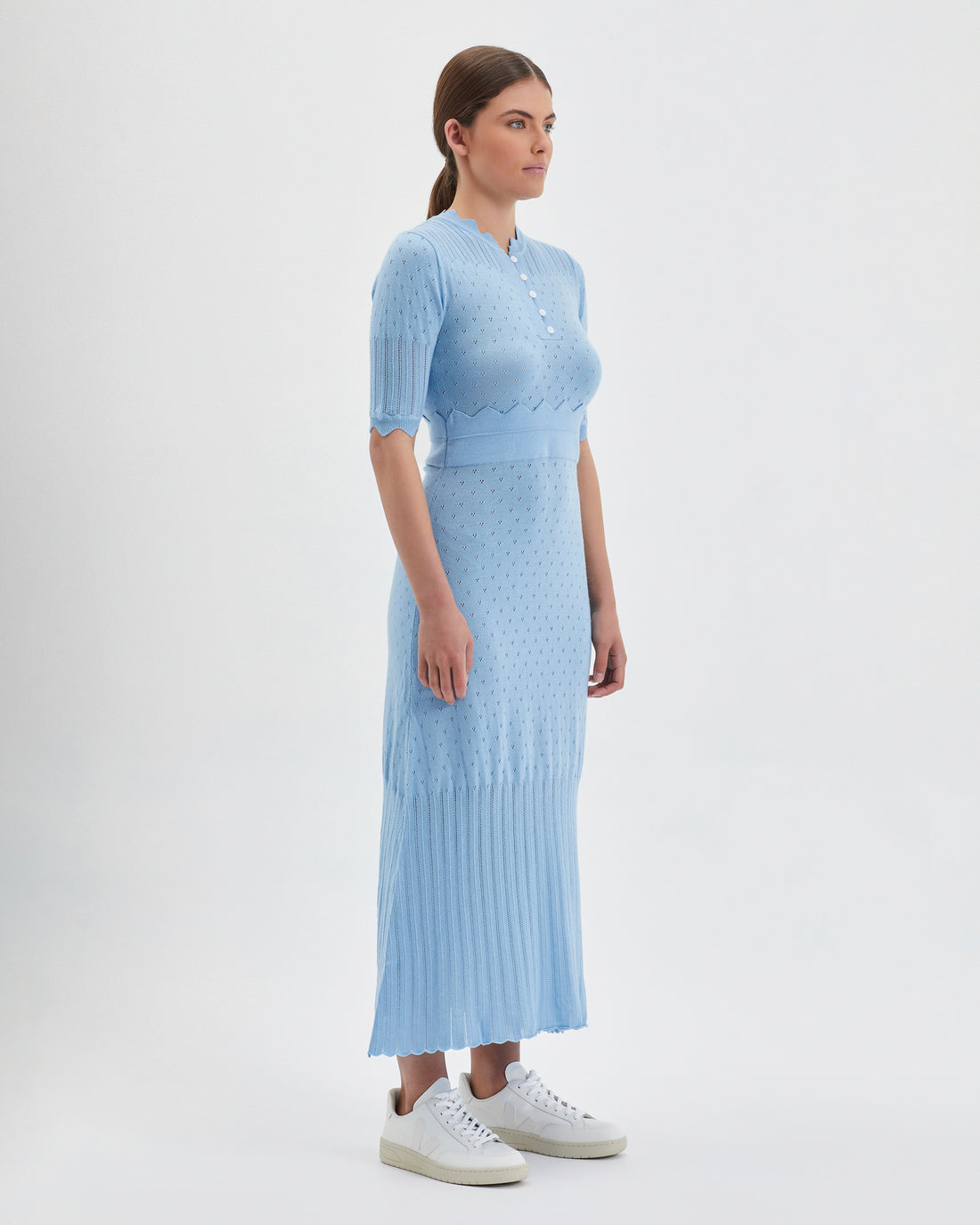 Merino wool knit dress in seafoam with delicate button details and pleated skirt.