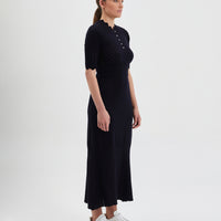 Classic black wool knit dress with button details, crafted from merino wool.