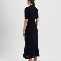 The dress features a fitted bodice with short sleeves, intricate pointelle details.