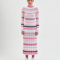 Colorful merino wool knit dress with playful stripe pattern.