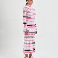 The wool dress is designed with a ribbed knit pattern that elegantly contours the figure.