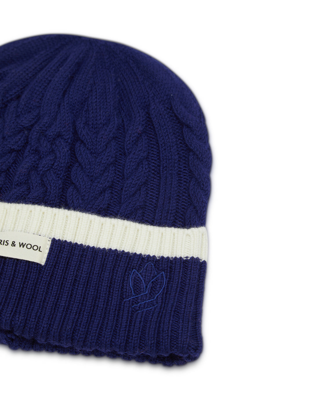 Navy merino wool beanie with elegant plaited design for women.