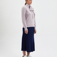 Elegant rose melange wool sweater with bow detail, perfect for day-to-night style.
