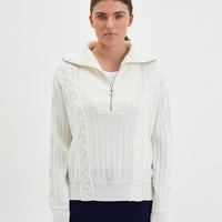 Close-up of half-zip Nerida Sweater in ivory Merino wool, offering relaxed style.