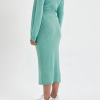 Sage merino wool midi skirt for stylish and warm winter layering.