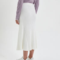 Classic ivory merino wool midi skirt with soft, luxurious texture.