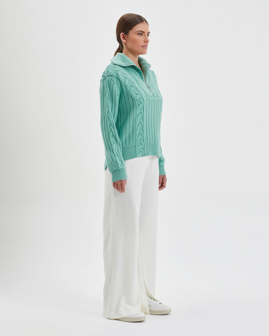 Half-zip wool sweater in sage Merino wool, perfect for casual winter layering.