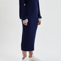 Elegant merino wool midi skirt in navy for versatile day-to-night wear.