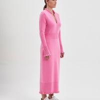 Romantic wool knit dress in candy with flattering waist and merino wool fabric.