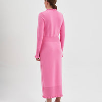 Back view of the candy pink little river merino wool dress with romantic frills.