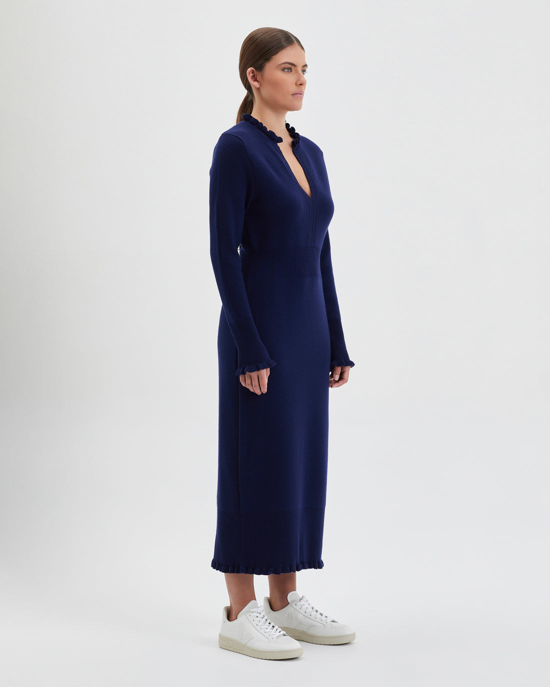 Navy merino wool knit dress with flattering, streamlined silhouette.
