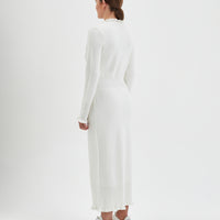 Back view of the ivory little river wool dress with romantic frills.