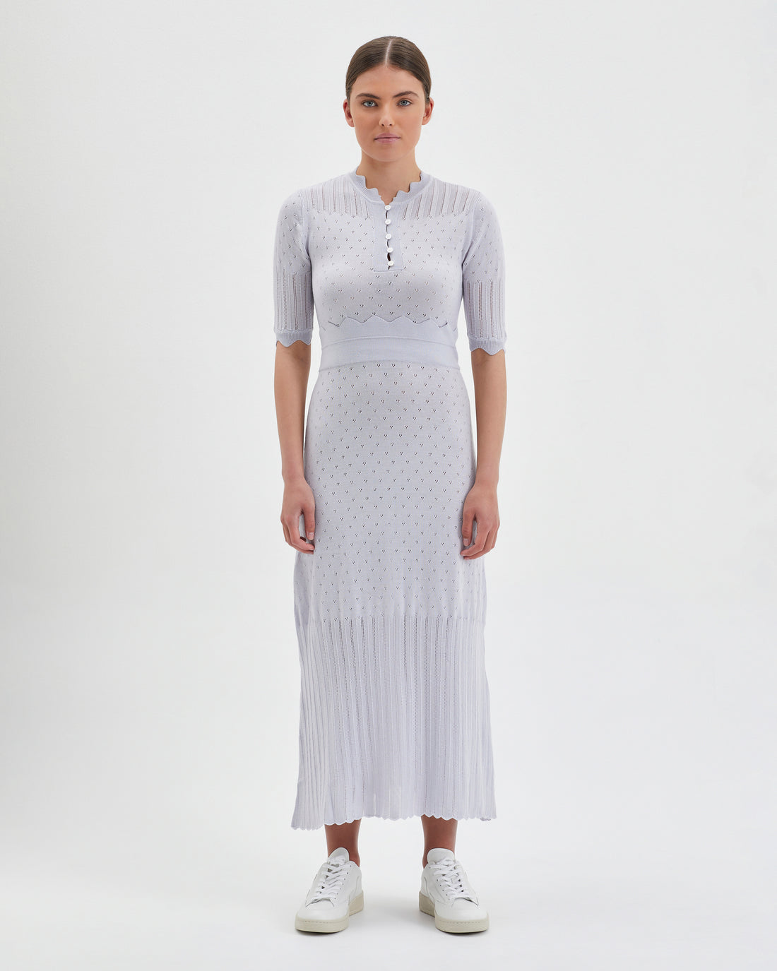 Close-up of Pointelle Knit Dress in Pearl with corset bodice and pleated skirt.