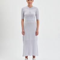 Close-up of Pointelle Knit Dress in Pearl with corset bodice and pleated skirt.