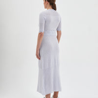 The dress features a fitted bodice with short sleeves, intricate pointelle details.