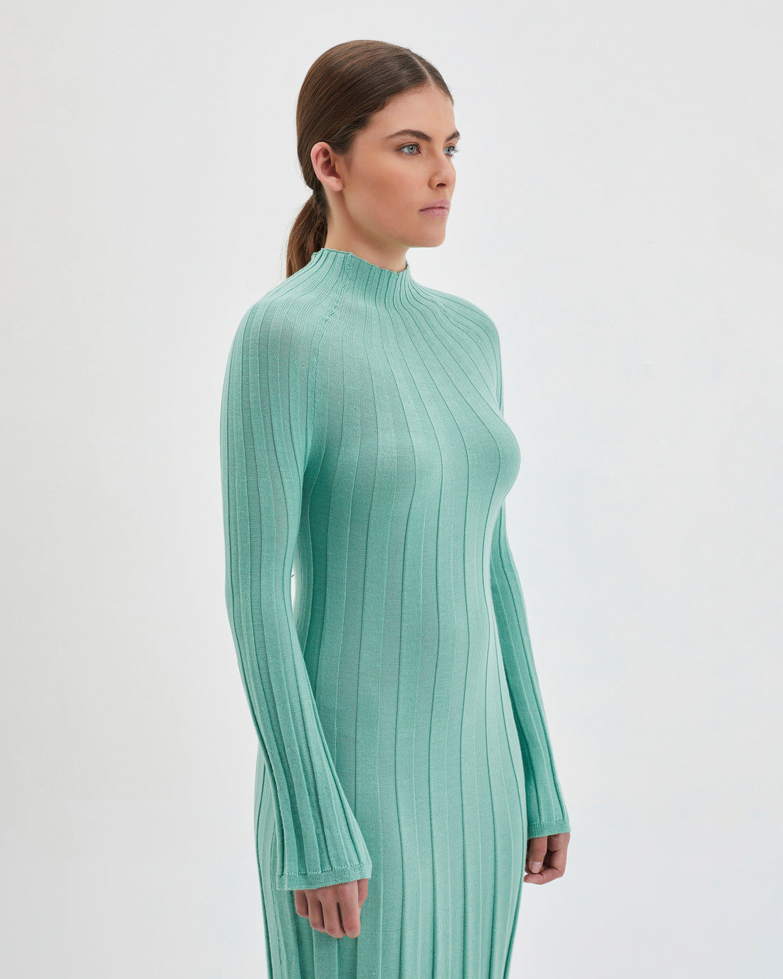 Elegant merino wool knit dress in sage, perfect for winter style.