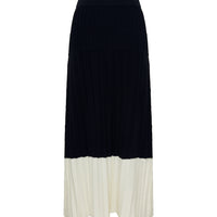 Close-up of Black Merino Wool Skirt – soft pleats and contrast cream hem
