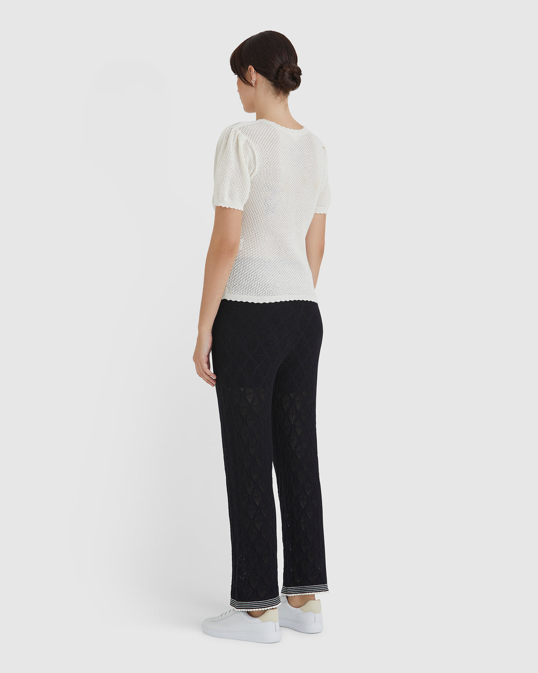 Back view of feminine gathered shoulder detail of the ruby pointelle top.