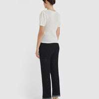 Back view of feminine gathered shoulder detail of the ruby pointelle top.