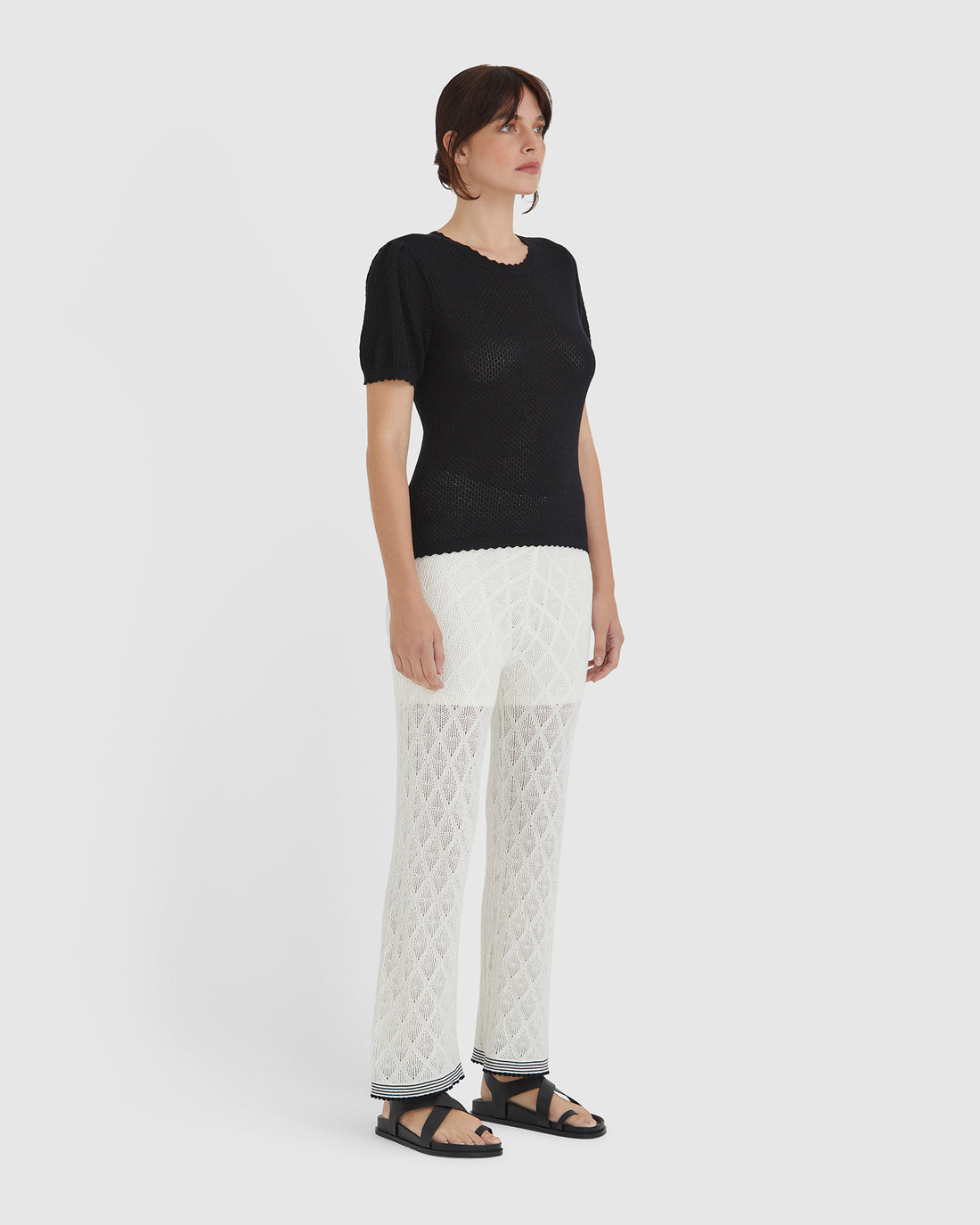 Elegant black merino wool and cotton blend top, ideal for versatile and timeless styling.