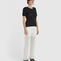 Elegant black merino wool and cotton blend top, ideal for versatile and timeless styling.