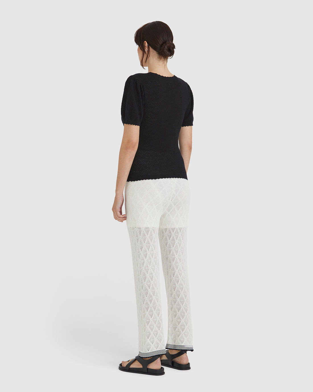 Back view of feminine gathered shoulder detail of the ruby pointelle top.
