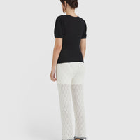 Back view of feminine gathered shoulder detail of the ruby pointelle top.