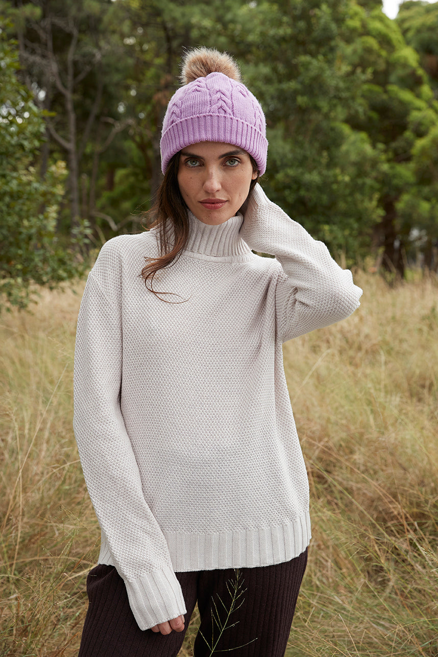 Cherry Blossom merino wool beanie with cable-knit design for women.