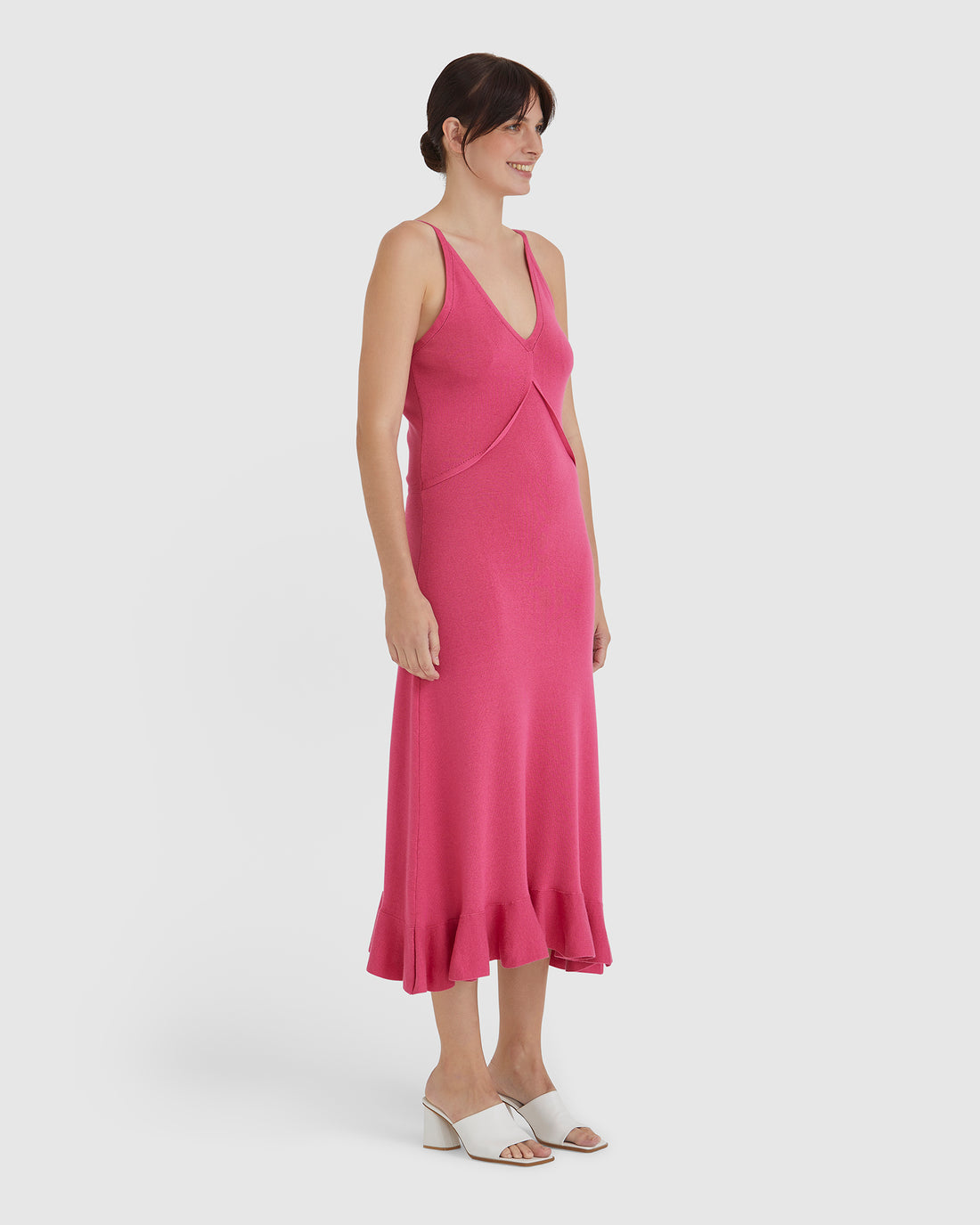 Elegant merino wool dress in pomegranate with fluted frill hem.