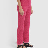 Elegant pomegranate lace pants, crafted from merino wool blend for versatile summer styling.