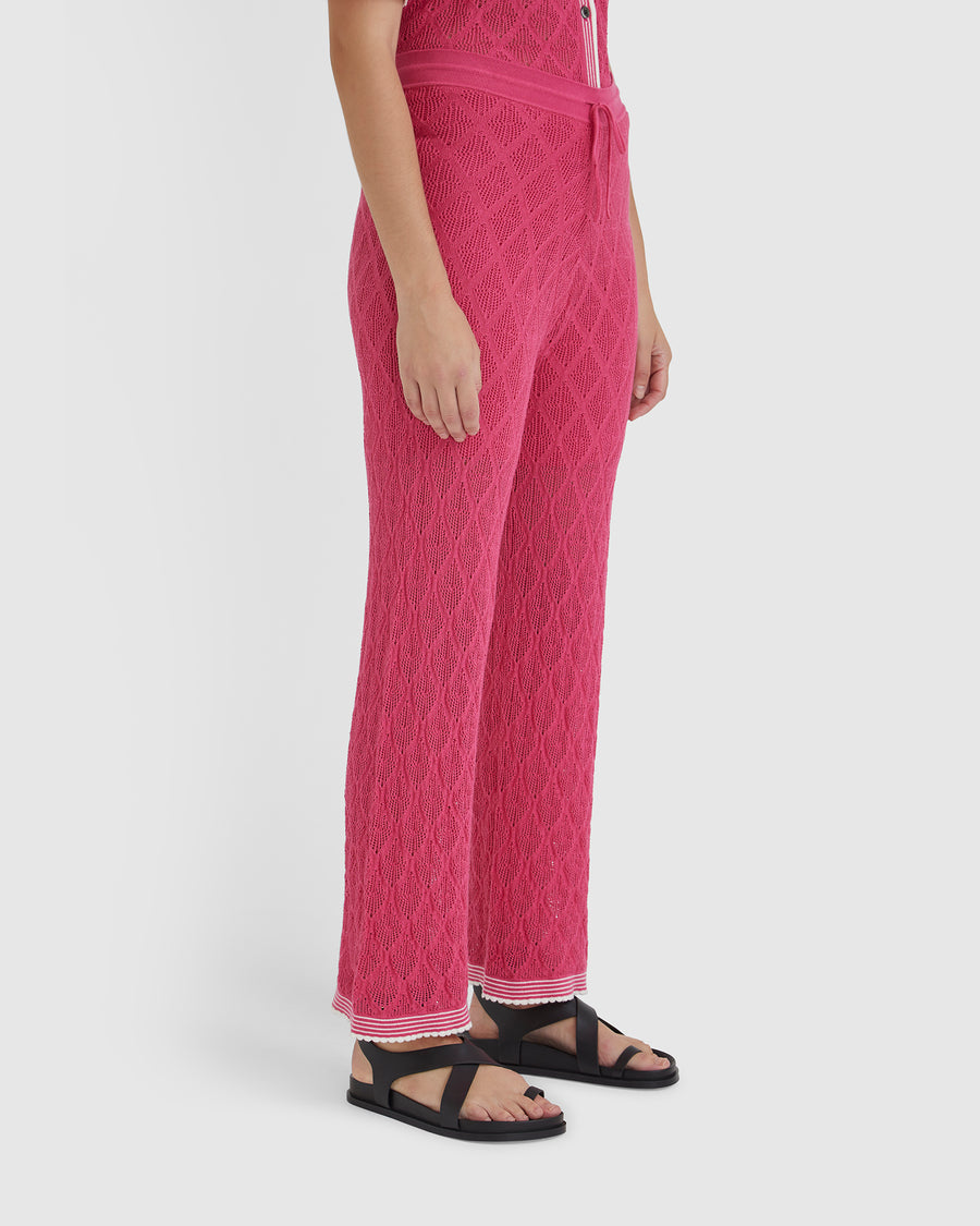 Elegant pomegranate lace pants, crafted from merino wool blend for versatile summer styling.