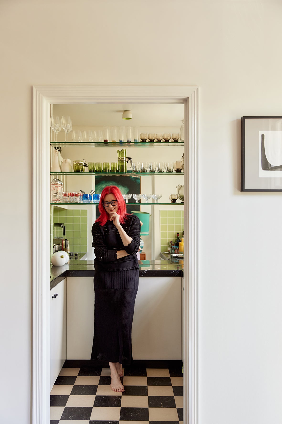 Glynis adds a cozy touch with a soft Australian Merino wool vest.