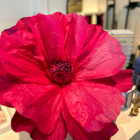 Giant paper flower in red with handcrafted petals for versatile display.