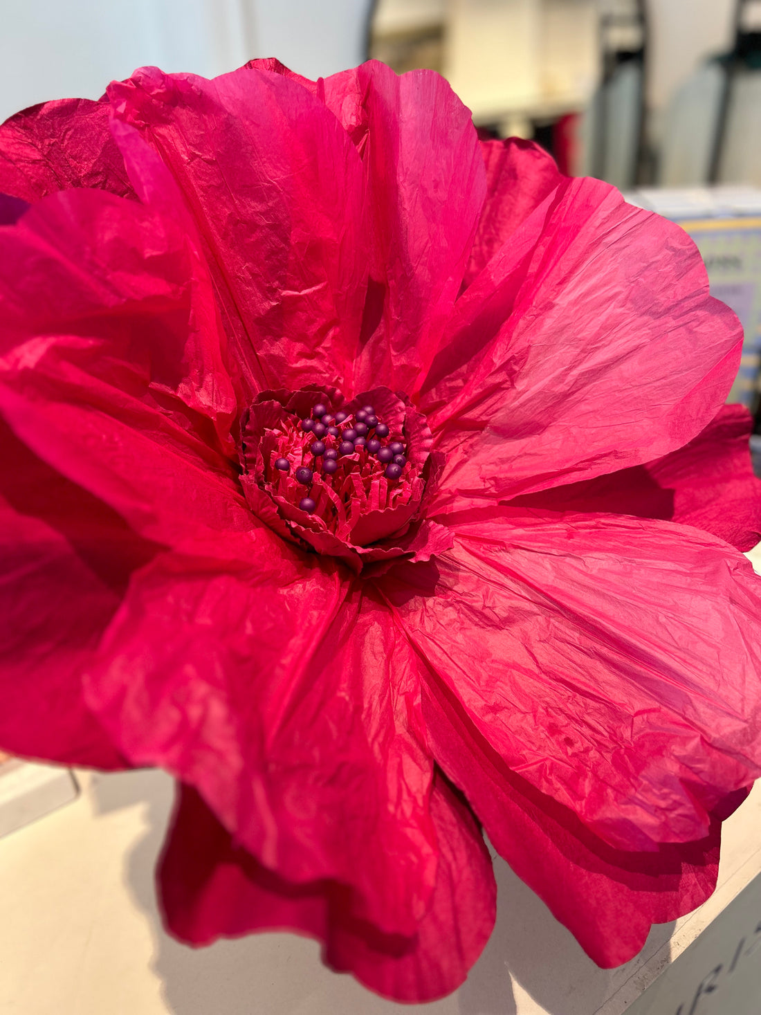 Red paper flower made from eco-friendly Saa paper with adjustable petals.